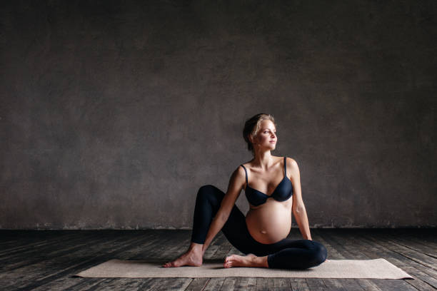 istock Young beautiful  pregnant yoga posing in studio 923283230