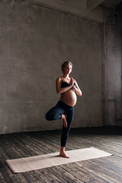 istock Young beautiful  pregnant yoga posing in studio 923283482