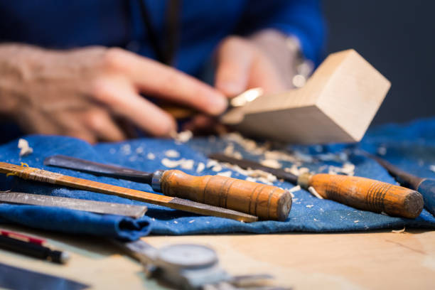 istock craftsperson carving violin 923289054
