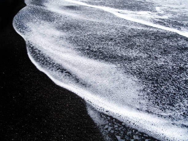 istock Abstract white sea foam and black sand. 923296806