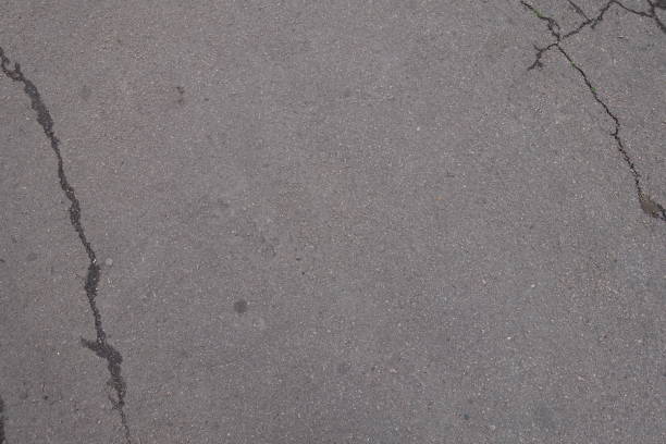 istock Top view of grey asphalt with cracks 923297138
