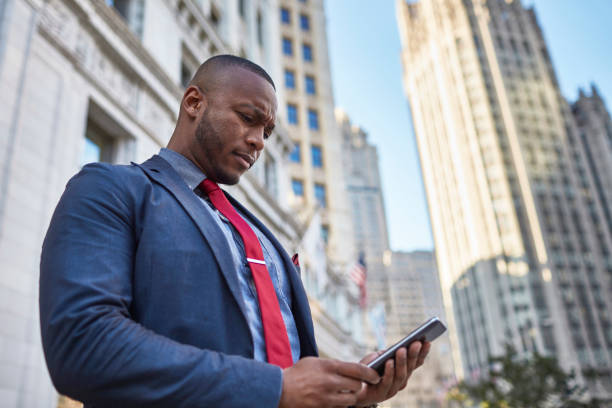 istock Businessman checking his mobile phone in downtown Chicago 923304838