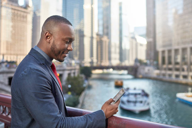 istock Businessman checking his mobile phone in downtown Chicago 923305094