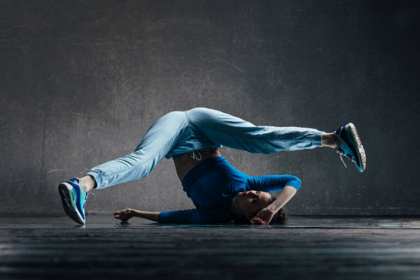 istock Young beautiful female dancer is posing in the studio 923305218