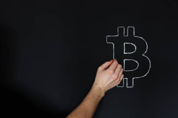 istock Man hand drawing Bitcoin on blackboard with chalk. 923309818