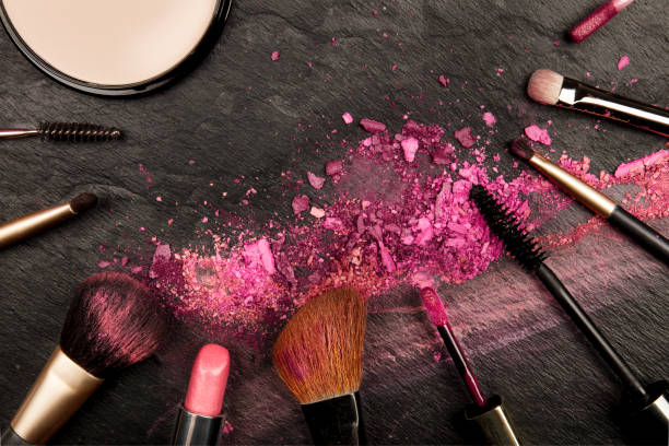 istock Closeup of makeup brushes with eye shadow and powder on black with copy space 923313002