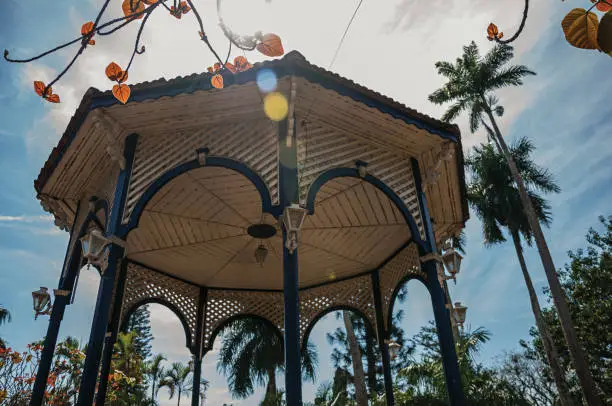 Close-up of colorful gazebo ceiling in the middle of garden full of trees, in a bright sunny day at São Manuel. A cute little town in the countryside of São Paulo State. Southeast Brazil.