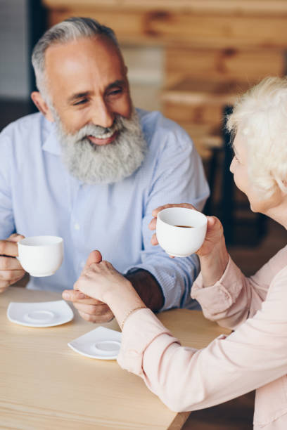 istock senior couple drinking coffee in cafe 923315452