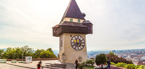 Graz: Medieval clock tower Uhrtrum in Schlossberg Castle public park around hill, symbol of Styria region of Austria.