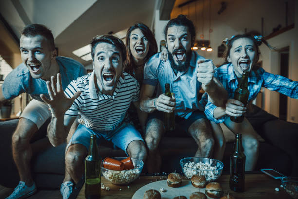 istock Excited fans having fun while cheering for their team at home. 923316854