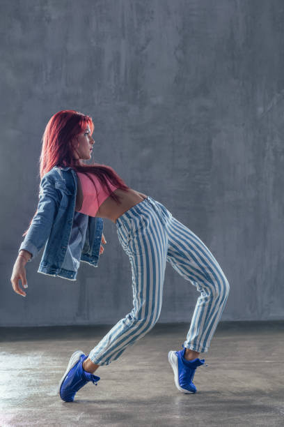 istock Young beautiful female dancer is posing in the studio 923317104
