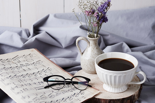 Black coffee and music note on bed