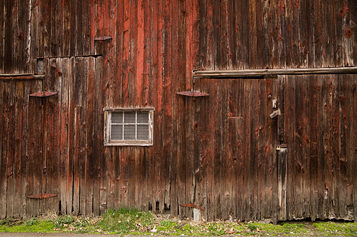Weathered wooden window shutters of rustic cabin, rural building in Switzerland