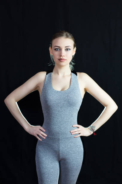 istock Slim athletic girl on a black background. 923327598