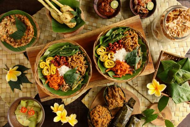 nasi campur bali, una popular comida balinesa de arroz con variedad de platos - balinese culture fotografías e imágenes de stock