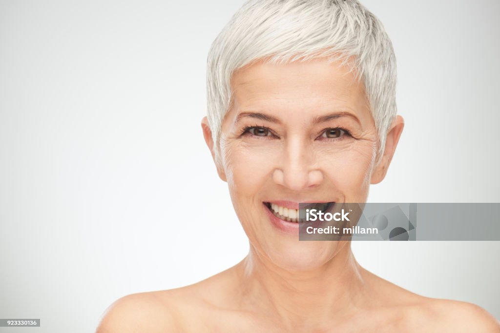 Portrait of beautiful senior woman. Portrait of beautiful senior woman in front of white background. Women Stock Photo