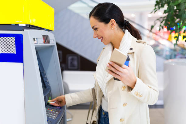 istock Woman withdrawing cash at an ATM 923330246