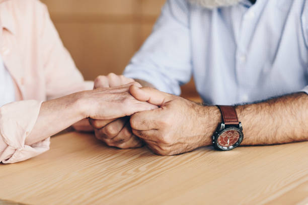 istock senior couple holding hands 923330490