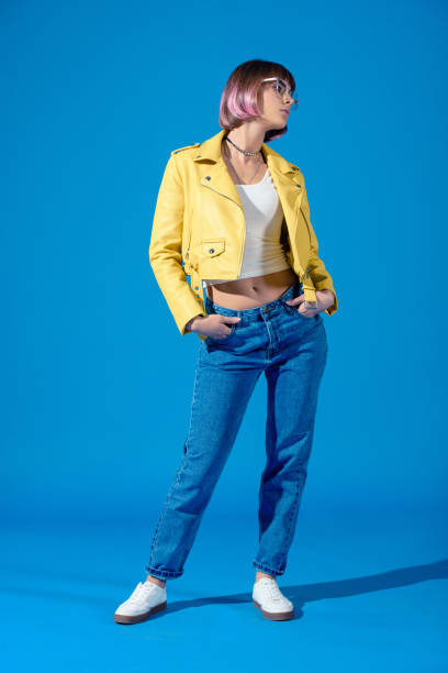 istock stylish girl posing in jeans and leather jacket on blue 923330640