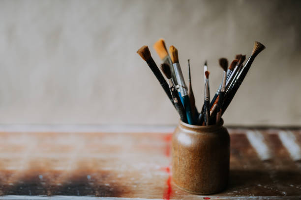 istock Photo of clean paint brushes in a ceramic jar. 923333978