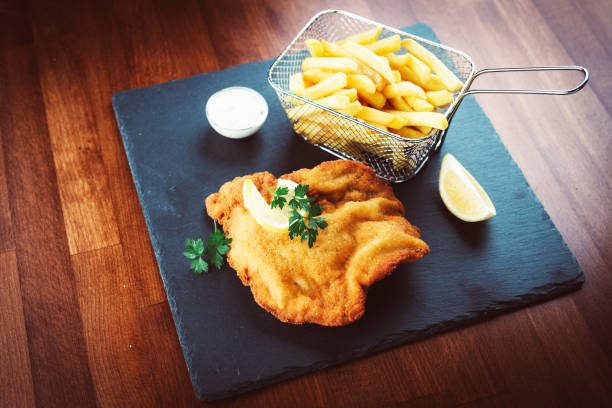 istock Wiener schnitzel with fried potatoes 923335792