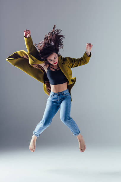 istock Young beautiful female dancer is posing in the studio 923335912