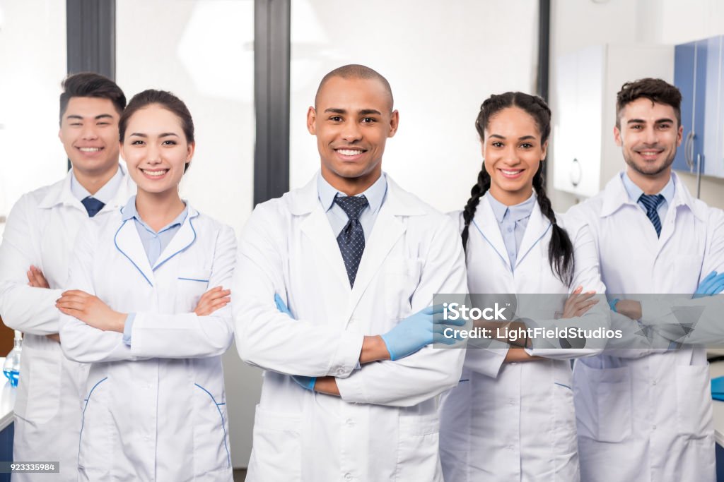 Team of professional doctors Team of young professional doctors standing together in laboratory, posing with arms crossed Doctor Stock Photo