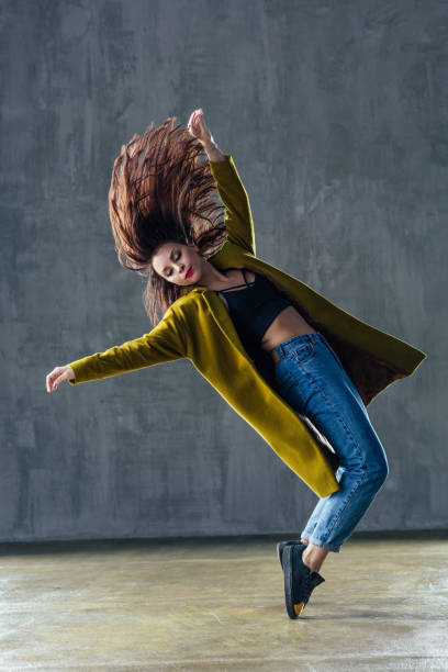 istock Young beautiful female dancer is posing in the studio 923338120