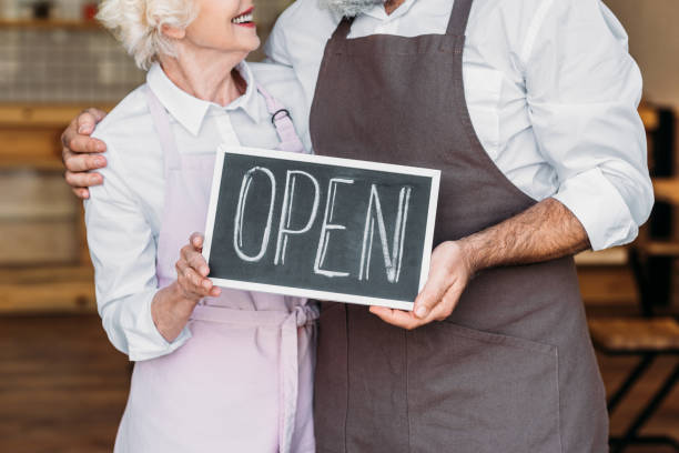 istock coffee shop owners with open chalkboard 923340120
