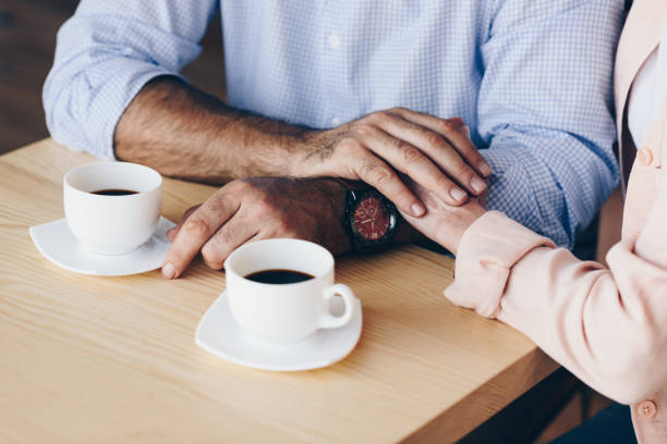 istock couple at table with cups of coffee 923340162