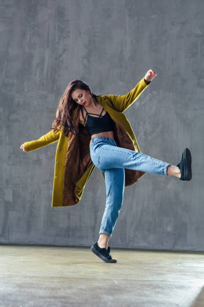 istock Young beautiful female dancer is posing in the studio 923340764