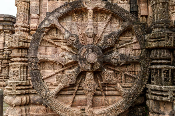 Stone wheel Intricate carvings on a stone wheel in the ancient  Hindu Sun Temple at Konark, Orissa, India. chariot wheel at konark sun temple india stock pictures, royalty-free photos & images
