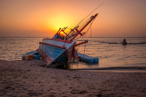 istock An old shipwreck or abandoned shipwreck.,Wrecked boat abandoned stand on beach or Shipwrecked off the coast of Thailand. 923359498