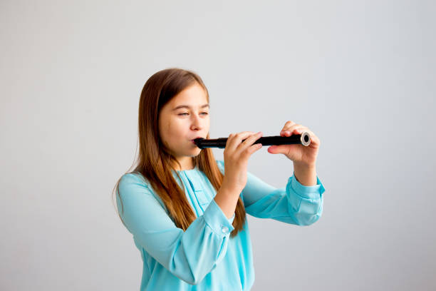 istock Girl playing flute 923359812