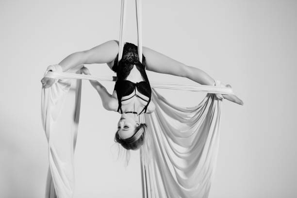 istock Beautiful aerialist girl doing acrobatic tricks 923364624
