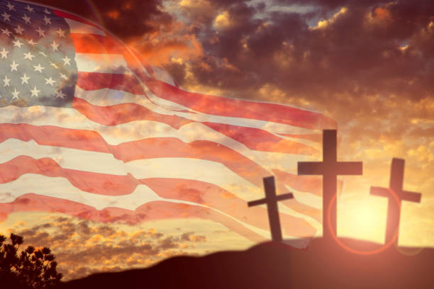 USA flag overlay on sunset sky with three Christianity crosses standing on a hill for Good Friday, Easter holidays.