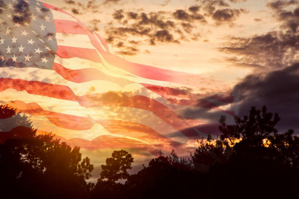 istock USA flag overlay on dramatic sunset sky. 923370008