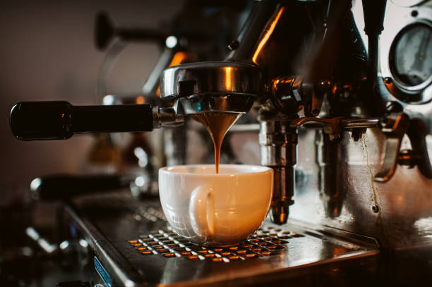 Espresso machine espresso machine pouring coffee into cups espresso photos stock pictures, royalty-free photos & images