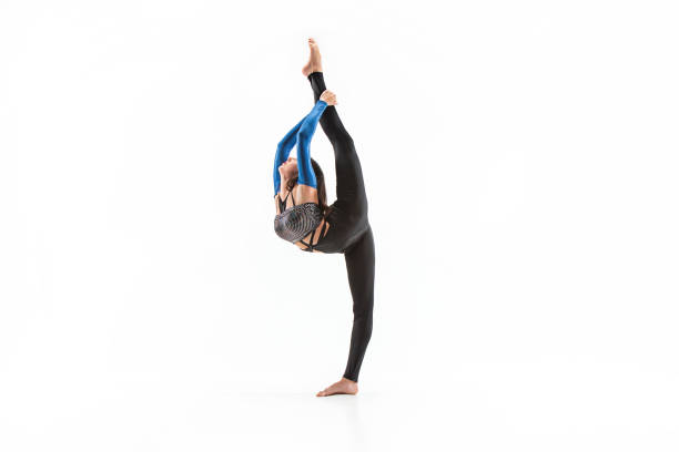 istock young sporty woman doing acrobatic exercise 923372084