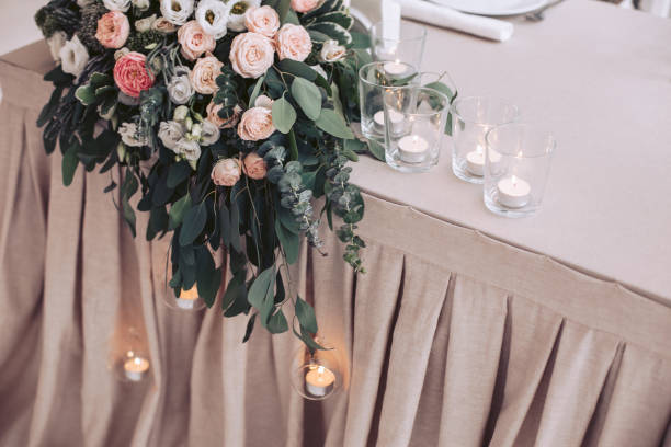 istock Wedding flower arrangement on the table and lighted candles in candlesticks 923375744