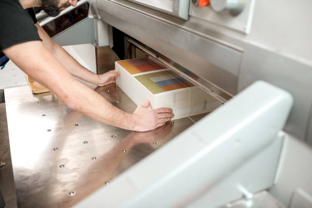 istock Cutting a stack of paper for printing at the factory 923383358