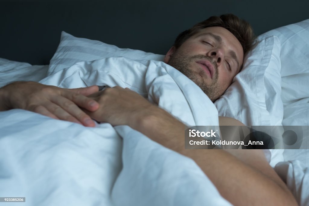 caucasian man napping with happy face expression. caucasian man napping with happy face expression. He is calm. Sleeping Stock Photo