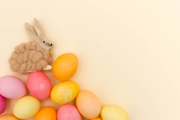 istock Easter bunny sitting on pile of easter eggs 923386586
