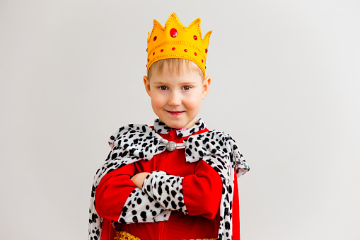 A portrait of a boy in a king costume