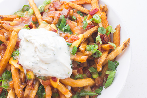 French fries loaded with bacon, American cheese, chives and sour cream