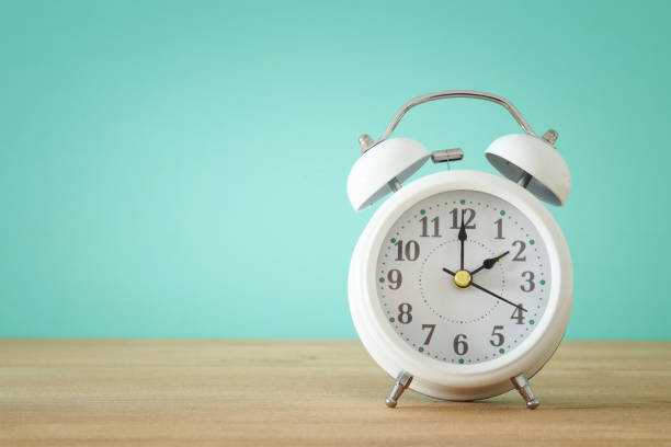 istock Image of spring Time Change. Summer back concept. Vintage alarm Clock over wooden table. 923394604