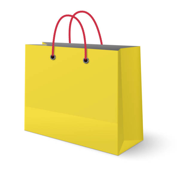 istock Ywllow paper shopping bag with red rope handles isolated on white background 923397150