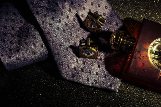 Attributes of an elegant man - tie with perfume and cufflinks