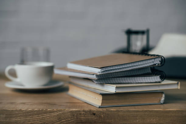 istock cup of coffee and stack of notebooks on work desk 923401548
