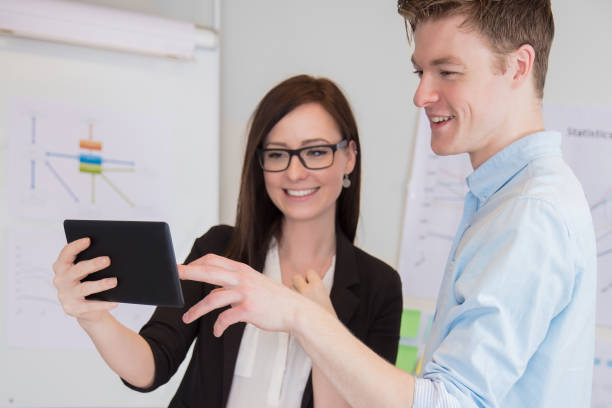 istock Businessman And Colleague Using Digital Tablet At Desk 923405452